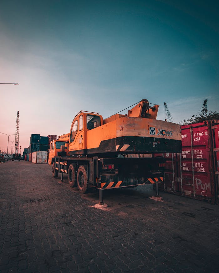 services-03 A bustling port with heavy machinery and containers during sunset in Tanjung Priok, Jakarta.